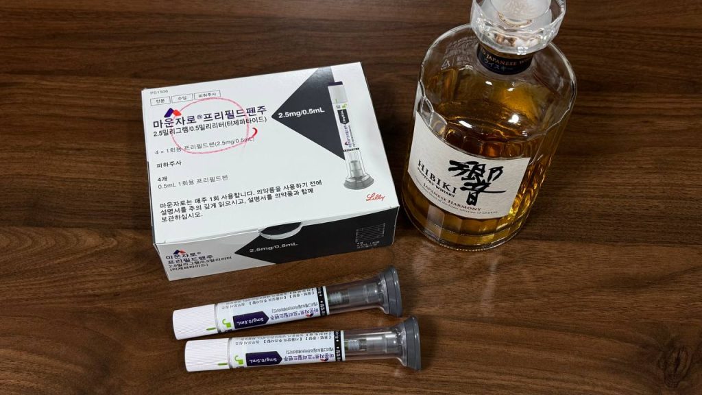 마운자로 5mg 투약 중 음주 시 위험성과 상호작용을 설명하기 위해 연출된 펜과 술 사진